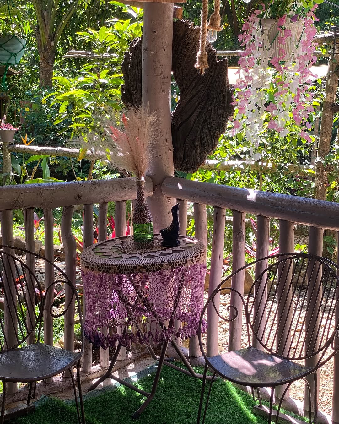 Garden tipi suite terrace with bistro table and tropical plants