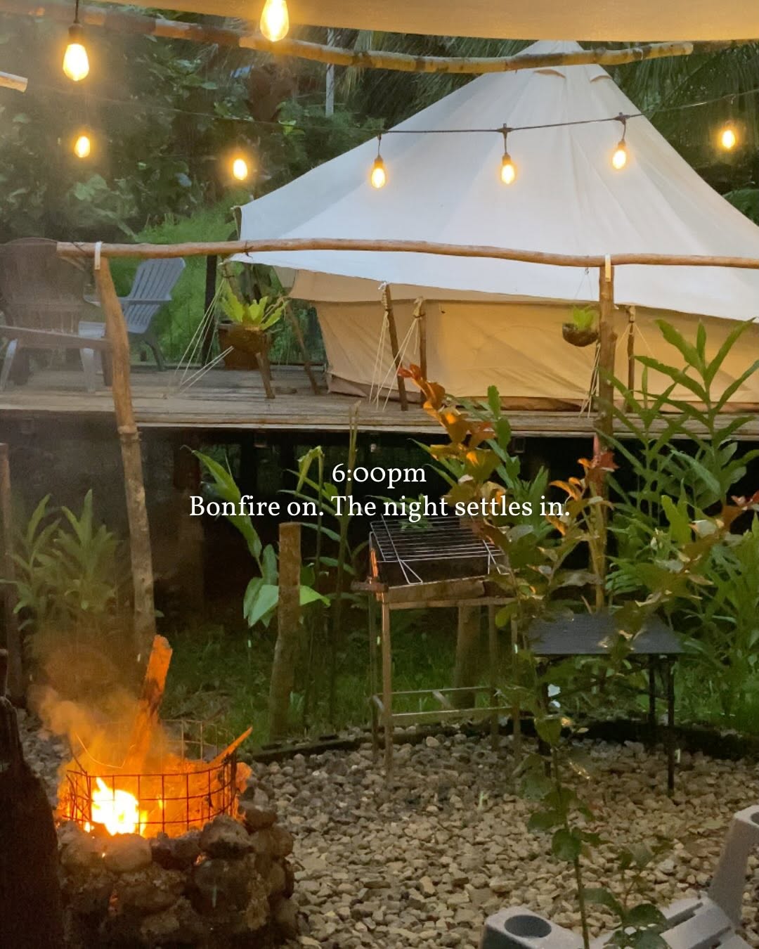 Evening bonfire with bell tent in the background