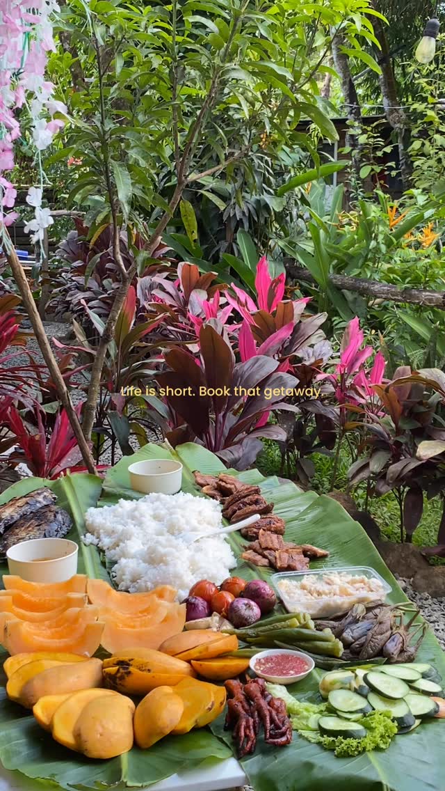 Filipino boodle fight food spread in the garden at Sapa de la Belle